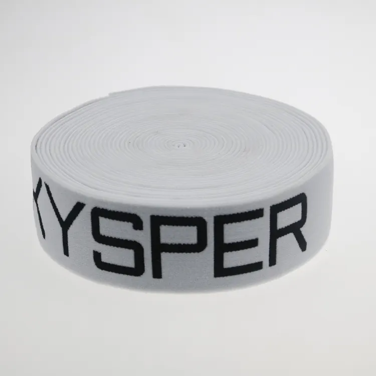 Roll of white nylon jacquard elastic webbing with black woven lettering