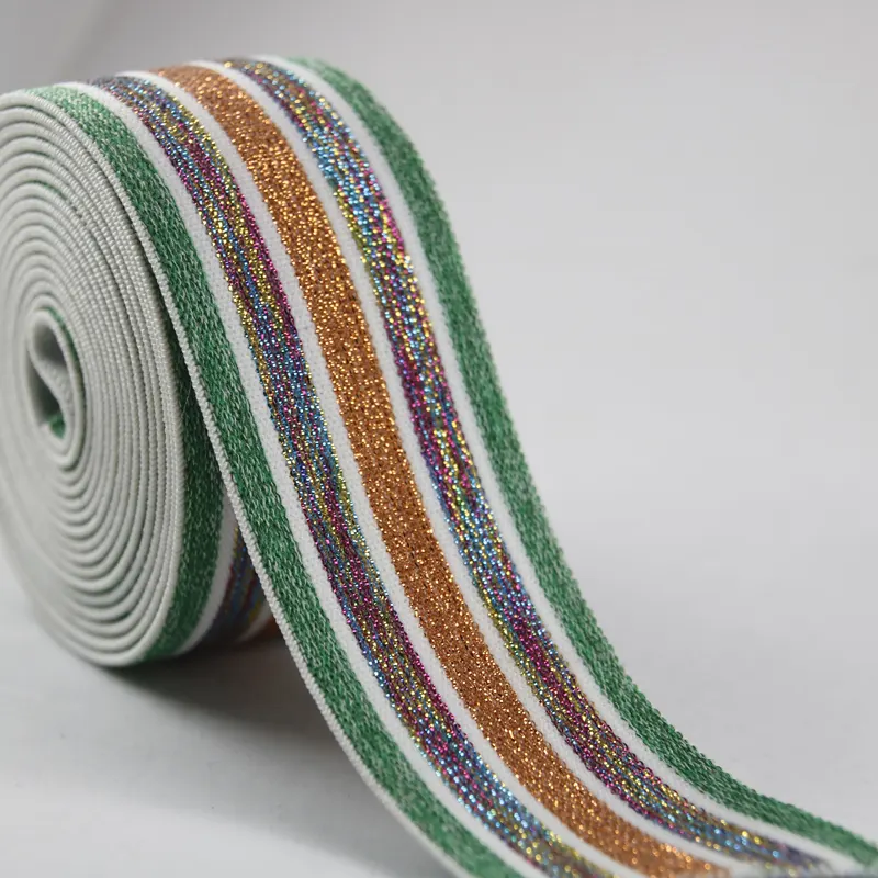 Roll of striped metallic elastic band displayed on a flat surface