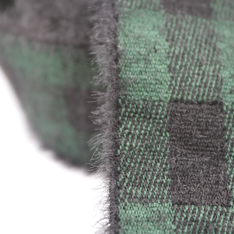Close-up of faux mink velvet elastic band showing the raised fuzzy pile and green and black plaid jacquard weave