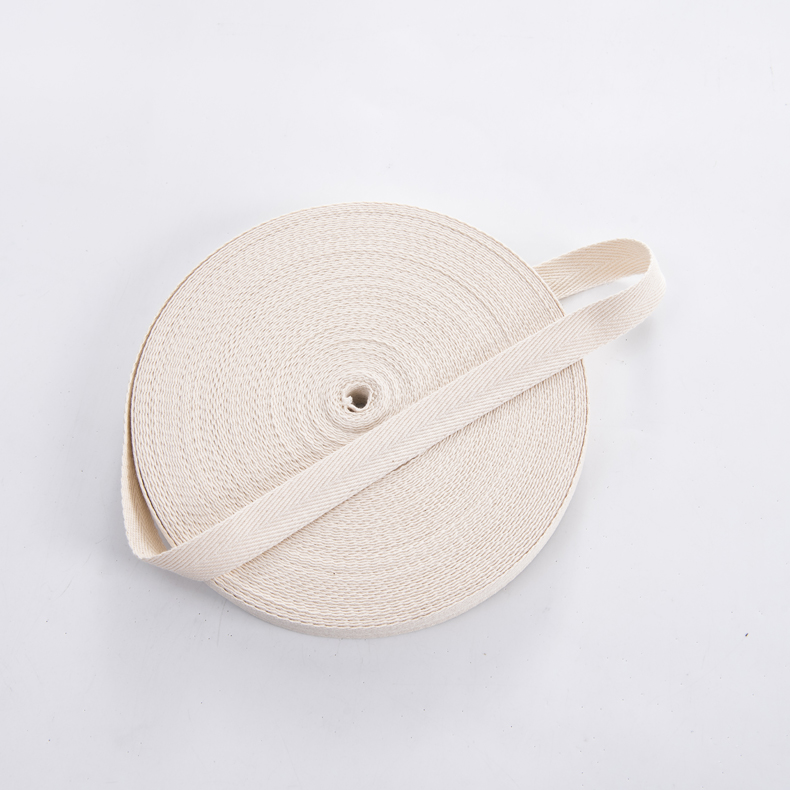 Cotton twill webbing rolled with a section unwound, showing the flat non-elastic tape surface