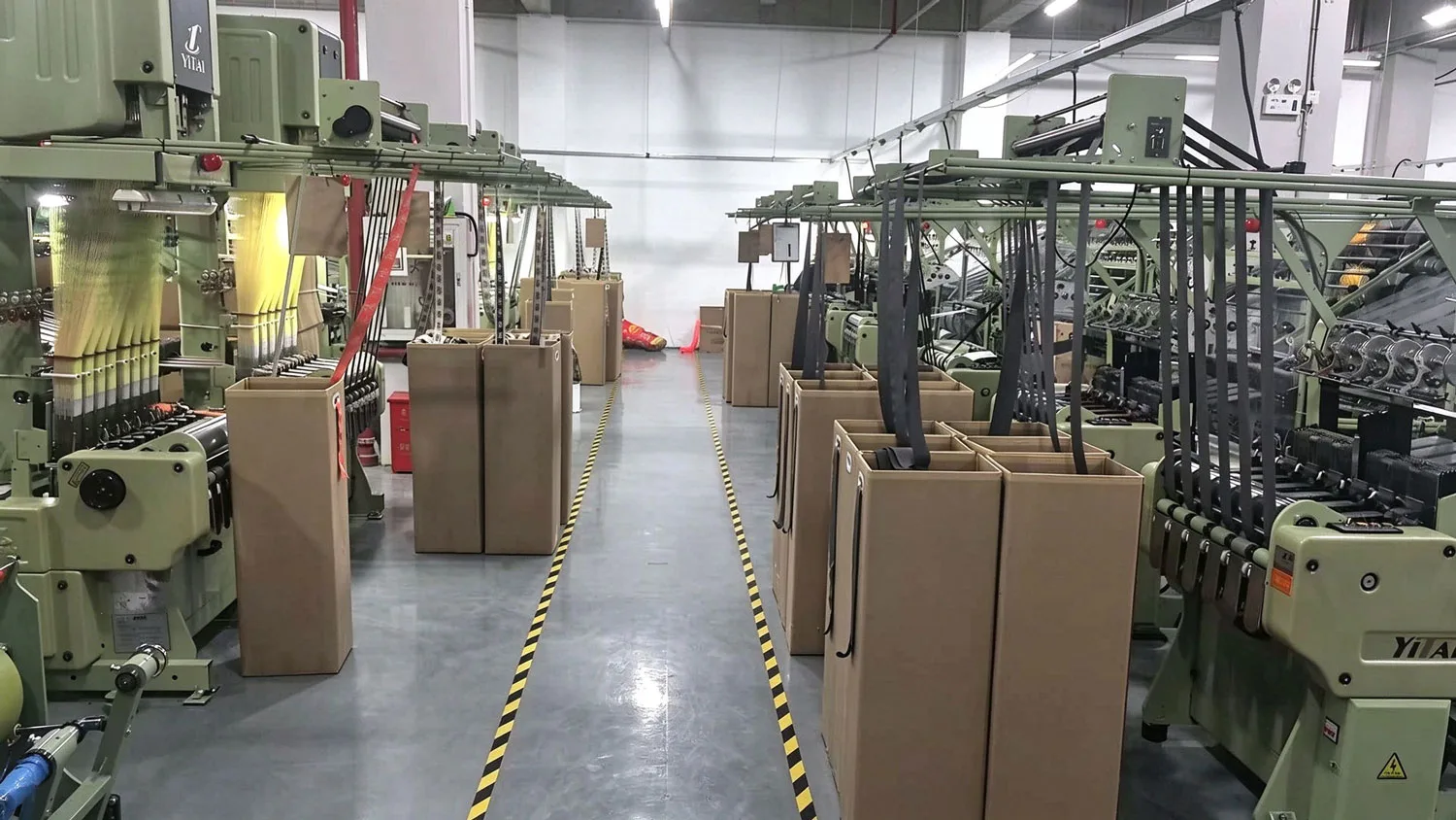 Rows of needle looms in the weaving hall of the Zivay Webbing elastic band factory
