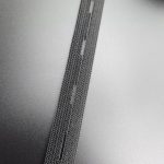 Buttonhole elastic tape running diagonally, showing the even spacing of the buttonholes