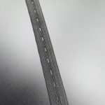 Buttonhole elastic tape close-up showing the woven elastic structure and the buttonhole slits