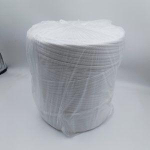 White ton bag leak-proof sealing strip coiled in a roll and wrapped in clear plastic film, shown on a plain light background