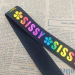 Close-up of laser printed elastic band showing sharp rainbow print detail on black nylon