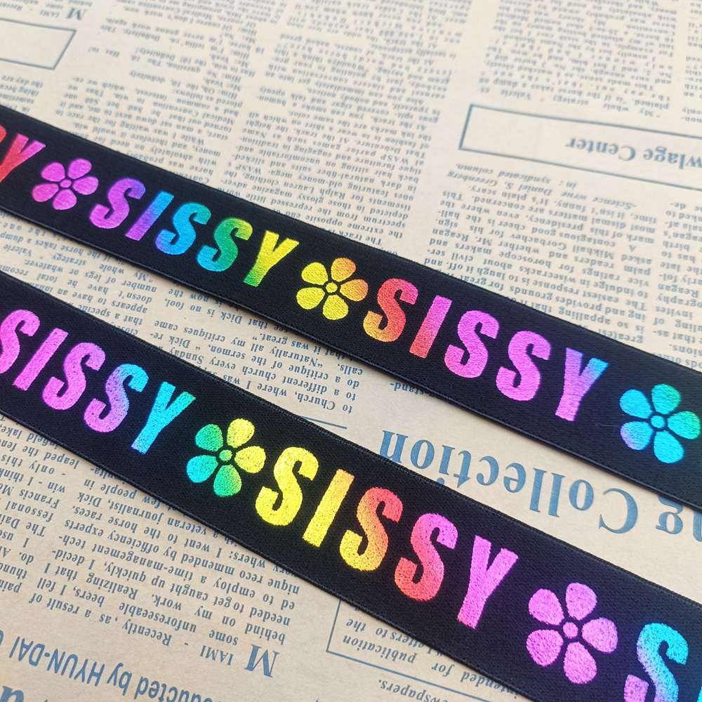 Custom laser printed elastic band in black with rainbow lettering and floral motifs