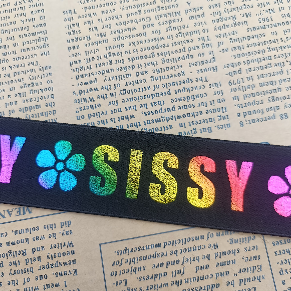 Laser printed elastic band laid on printed paper showing colour and texture