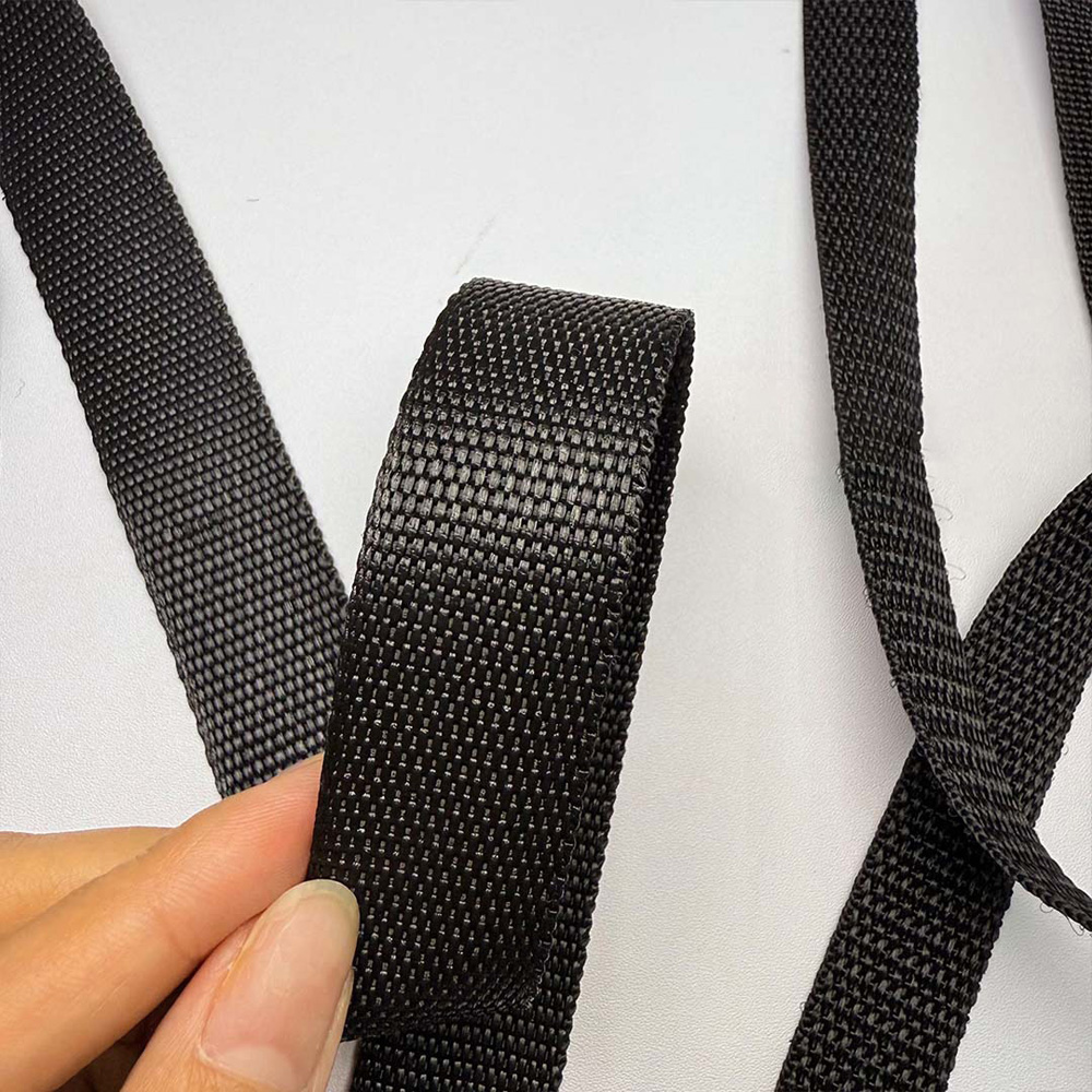 Plain weave black polypropylene webbing held by hand